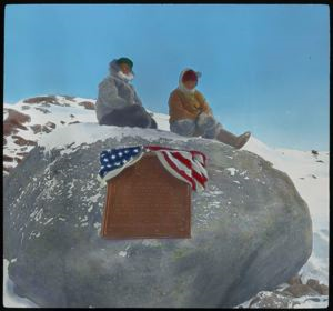 Image of MacMillan and Eskimo [Inuk] Seated on Boulder at Cape Sabine